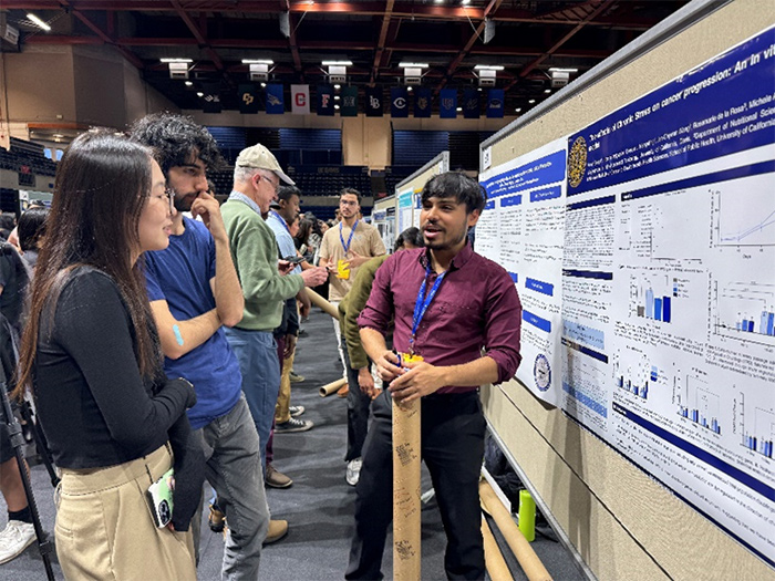 Aman Singla presenting his research at the 2024 Undergraduate Research, Scholarship and Creative Activities Conference. Photo Credit: Michele La Merrill